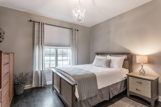 bedroom with a chandelier, baseboards, and dark wood-style floors