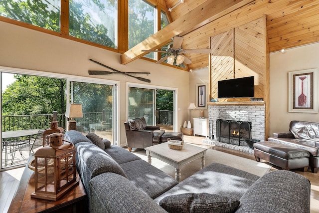 living room with wood finished floors, healthy amount of natural light, and a high ceiling