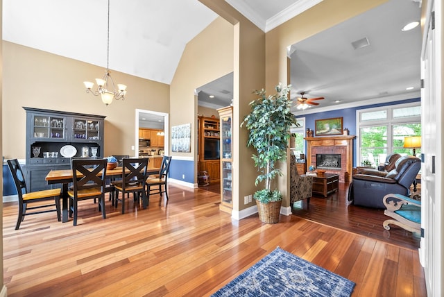 411 Lake Pointe Dr, Clarksville, TN 37043 - dining room featuring a brick fireplace, ceiling fan, hardwood / wood-style floors, baseboards, and ornamental molding