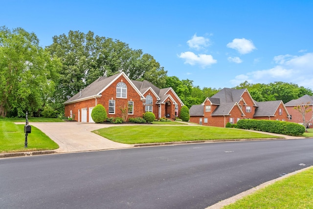 411 Lake Pointe Dr, Clarksville, TN 37043 - traditional home featuring brick siding, driveway, a garage, and a front lawn