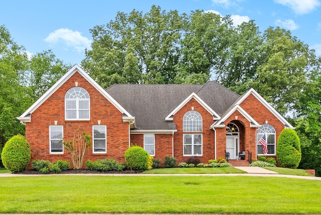 411 Lake Pointe Dr, Clarksville, TN 37043 - view of front of house with a front lawn, brick siding, and a shingled roof