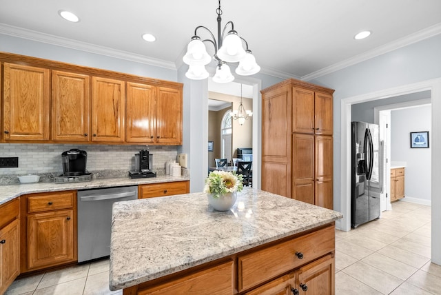 411 Lake Pointe Dr, Clarksville, TN 37043 - kitchen with appliances with stainless steel finishes, a chandelier, tasteful backsplash, brown cabinets, and light tile patterned floors