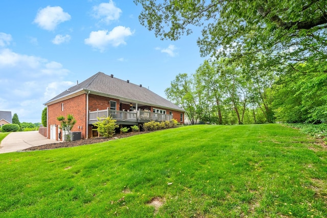 411 Lake Pointe Dr, Clarksville, TN 37043 - view of green lawn with central AC unit, driveway, a wooden deck, and an attached garage