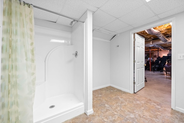 411 Lake Pointe Dr, Clarksville, TN 37043 - bathroom featuring a shower stall, a paneled ceiling, and baseboards