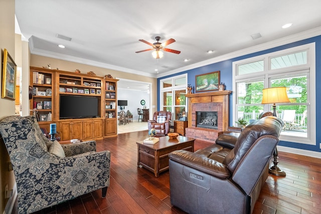 411 Lake Pointe Dr, Clarksville, TN 37043 - living room with dark wood-style flooring, a ceiling fan, a fireplace, crown molding, and baseboards