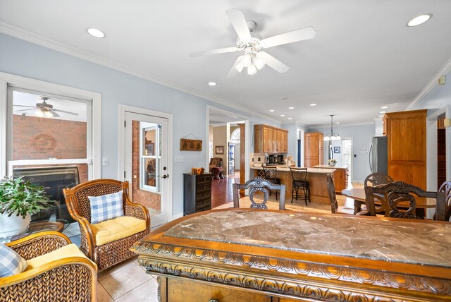 411 Lake Pointe Dr, Clarksville, TN 37043 - living area with ceiling fan, recessed lighting, crown molding, a fireplace, and light tile patterned flooring
