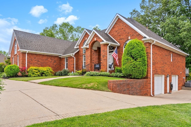 411 Lake Pointe Dr, Clarksville, TN 37043 - view of front of house with brick siding, driveway, a front yard, a shingled roof, and an attached garage