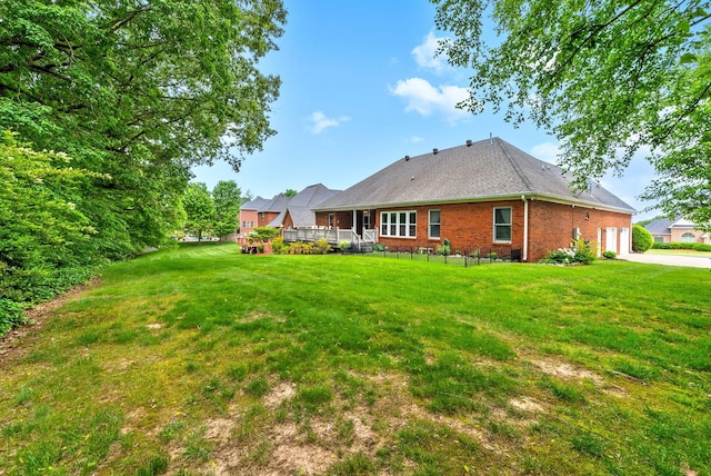 411 Lake Pointe Dr, Clarksville, TN 37043 - rear view of house featuring brick siding, driveway, a lawn, and a garage