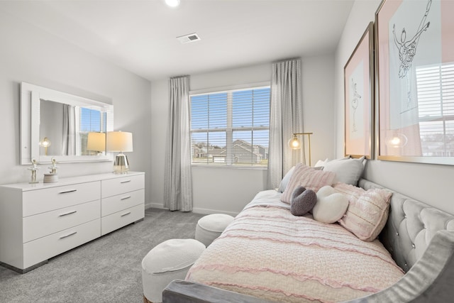bedroom featuring light colored carpet and baseboards