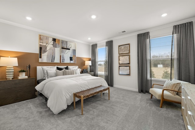 bedroom with crown molding, multiple windows, light colored carpet, recessed lighting, and baseboards