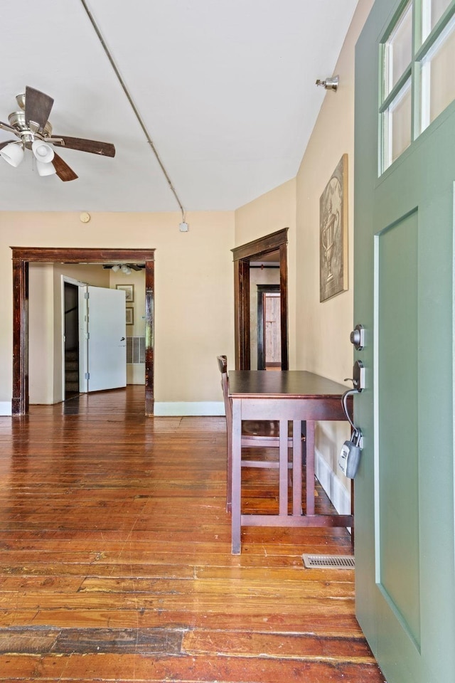 entryway with wood-type flooring, baseboards, and ceiling fan