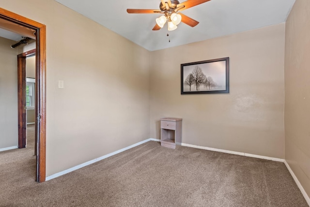 empty room featuring carpet floors, ceiling fan, and baseboards