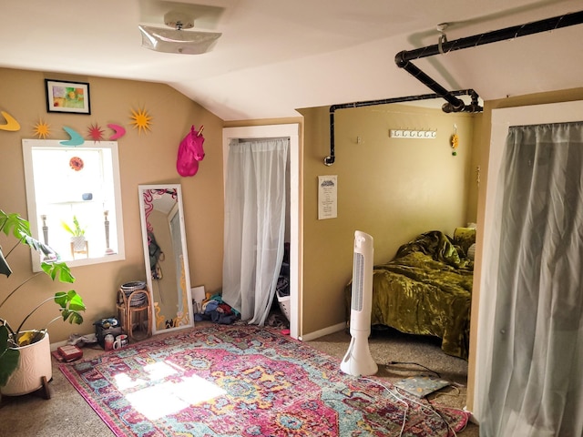 bedroom featuring lofted ceiling and carpet flooring