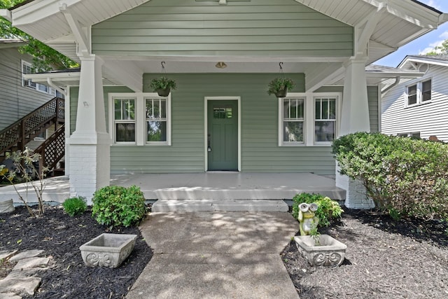 view of exterior entry featuring a porch