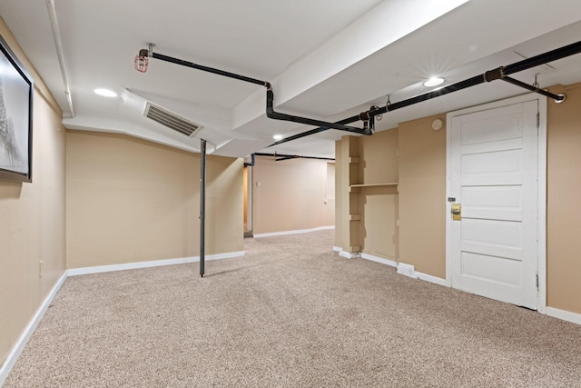 finished basement featuring carpet flooring, baseboards, and recessed lighting