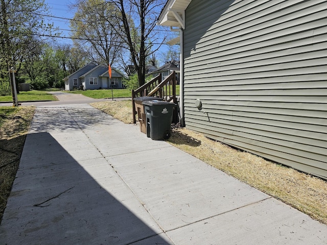 view of property exterior featuring driveway and a lawn
