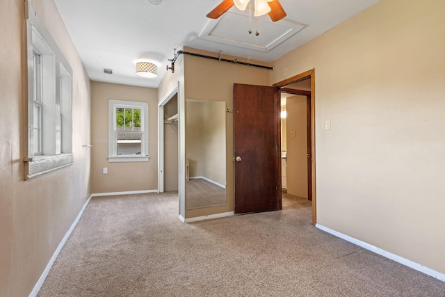 unfurnished bedroom with a closet, carpet floors, baseboards, and ceiling fan