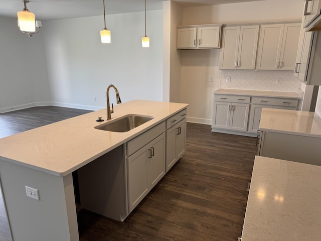 1085 June Wilde Rdg, Spring Hill, TN 37174 - kitchen featuring a sink, dark wood finished floors, baseboards, backsplash, and decorative light fixtures