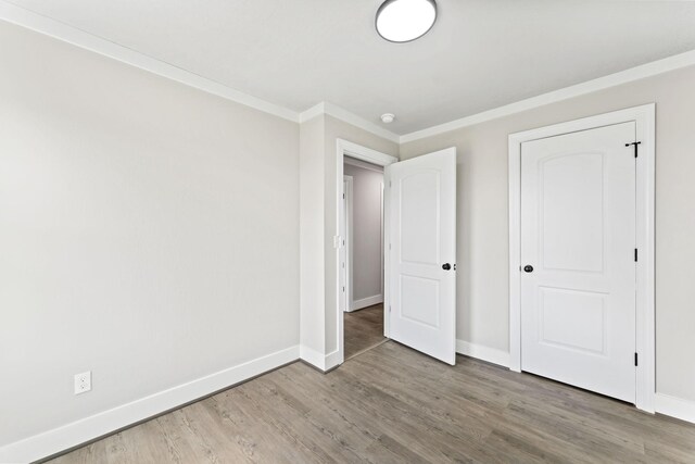 1950 Norton Rd, Lawrenceburg, TN 38464 - unfurnished bedroom with wood finished floors, baseboards, and crown molding