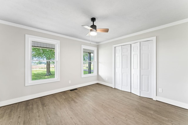 1950 Norton Rd, Lawrenceburg, TN 38464 - unfurnished bedroom featuring baseboards, wood finished floors, crown molding, a closet, and ceiling fan