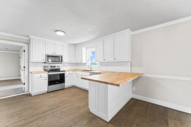 1950 Norton Rd, Lawrenceburg, TN 38464 - kitchen with stainless steel appliances, a sink, baseboards, backsplash, and a textured ceiling