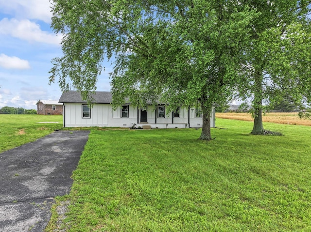 1950 Norton Rd, Lawrenceburg, TN 38464 - ranch-style house featuring board and batten siding, asphalt driveway, and a front yard