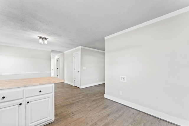 1950 Norton Rd, Lawrenceburg, TN 38464 - empty room with wood finished floors, baseboards, ornamental molding, and a textured ceiling