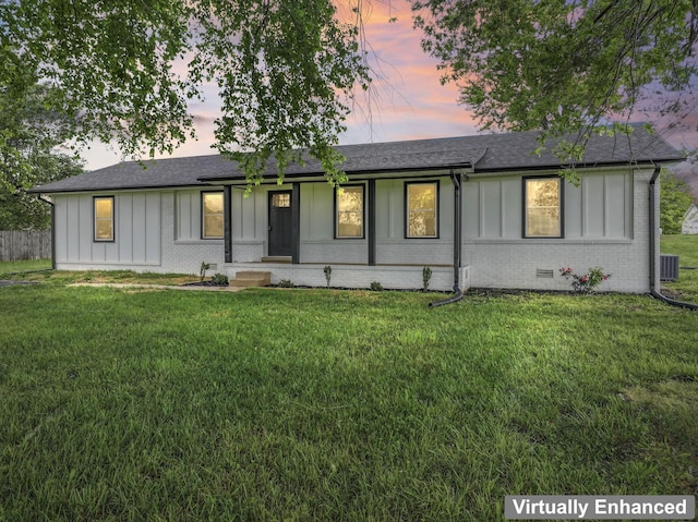 1950 Norton Rd, Lawrenceburg, TN 38464 - ranch-style home featuring board and batten siding, a lawn, brick siding, roof with shingles, and central AC