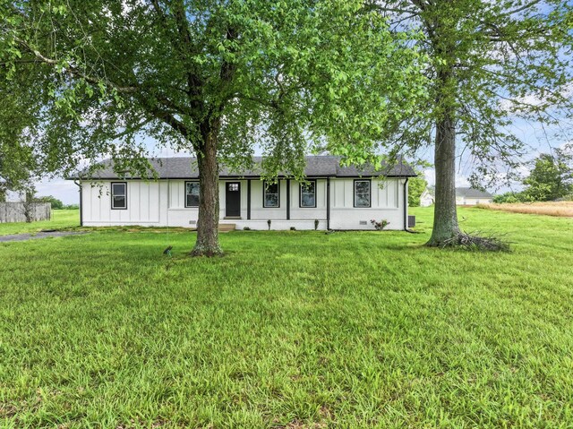 1950 Norton Rd, Lawrenceburg, TN 38464 - ranch-style house with board and batten siding, a front lawn, and roof with shingles