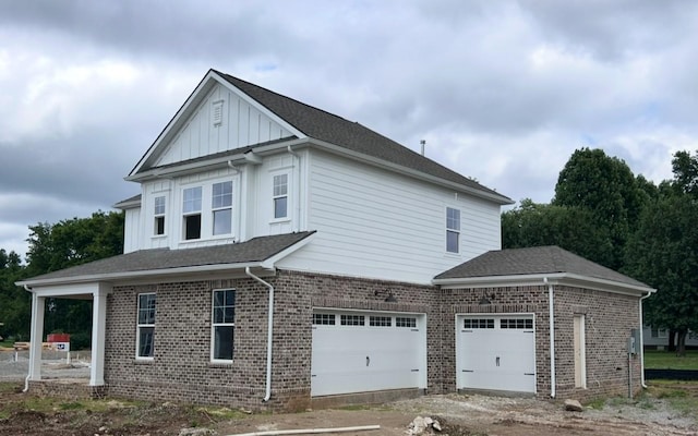 6161 Worthingtion Rd, Columbia, TN 38401 - view of home's exterior with brick siding, a garage, dirt driveway, and board and batten siding