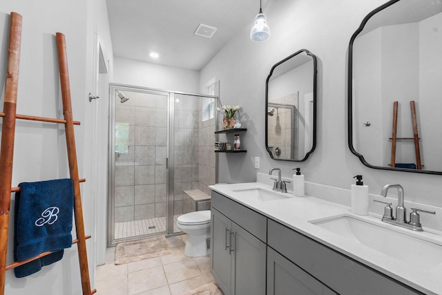 bathroom featuring a stall shower, toilet, double vanity, tile patterned floors, and recessed lighting
