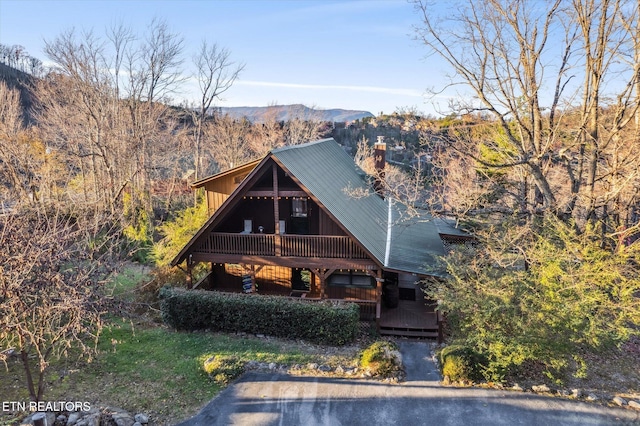 1640 Bench Mountain Way, Sevierville, TN 37862 - view of front of home with a mountain view, metal roof, a chimney, and covered porch