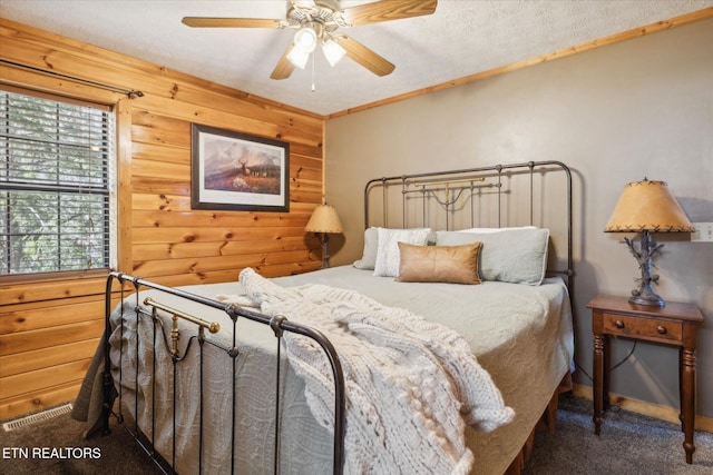 2409 Walnut Cove Way, Sevierville, TN 37862 - carpeted bedroom featuring wood walls and a ceiling fan
