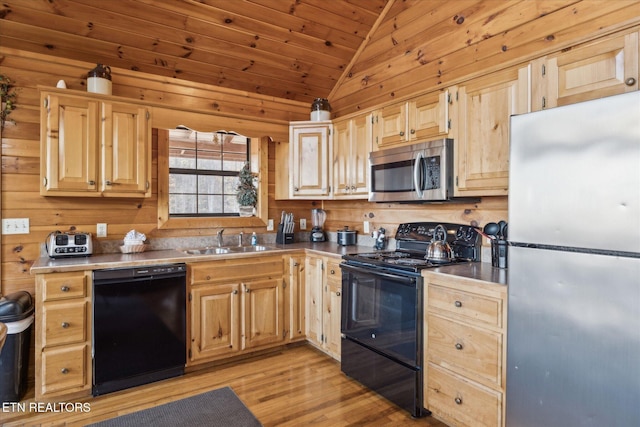 2409 Walnut Cove Way, Sevierville, TN 37862 - kitchen featuring black appliances, a sink, vaulted ceiling, light brown cabinetry, and light wood finished floors