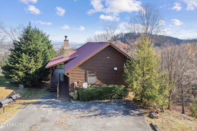 2409 Walnut Cove Way, Sevierville, TN 37862 - view of front of house with stairway, a chimney, metal roof, asphalt driveway, and a mountain view