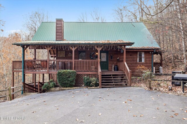 3514 Olde Tyme Way, Sevierville, TN 37862 - log home featuring covered porch, metal roof, faux log siding, and a chimney