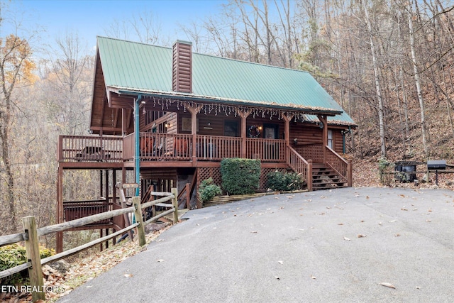 3514 Olde Tyme Way, Sevierville, TN 37862 - view of front of home with covered porch, a chimney, metal roof, and faux log siding