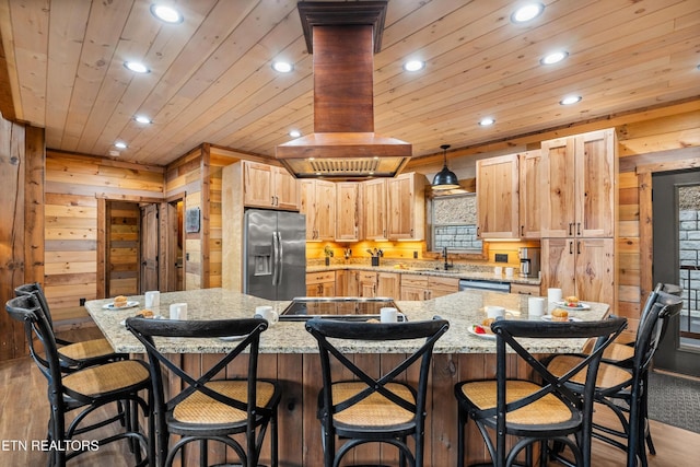 kitchen with appliances with stainless steel finishes, recessed lighting, wood walls, wood finished floors, and wood ceiling