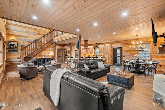 living area with wood walls, stairway, light wood finished floors, recessed lighting, and wooden ceiling