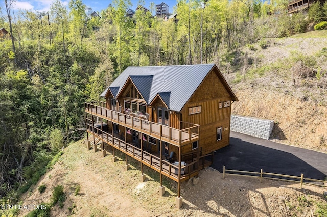 back of house featuring metal roof and a standing seam roof