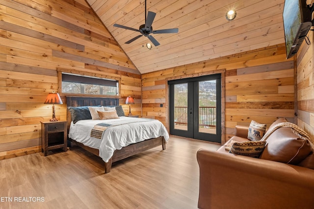 bedroom featuring vaulted ceiling, french doors, access to outside, wooden ceiling, and wooden walls