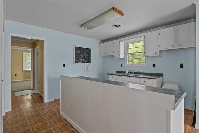 7158 Bahne Rd, Fairview, TN 37062 - kitchen with a sink, baseboards, and white cabinetry