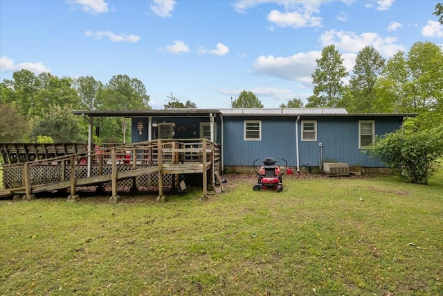 7158 Bahne Rd, Fairview, TN 37062 - back of property with a deck, a lawn, and central AC unit