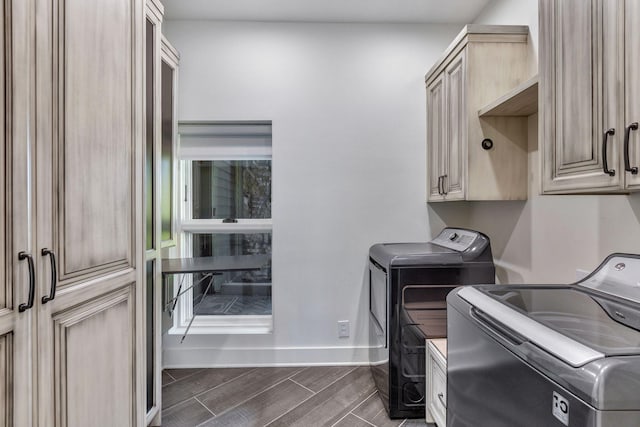 3910 Brick Church Pike, Nashville, TN 37207 - laundry room with washing machine and dryer, cabinet space, baseboards, and wood finish floors