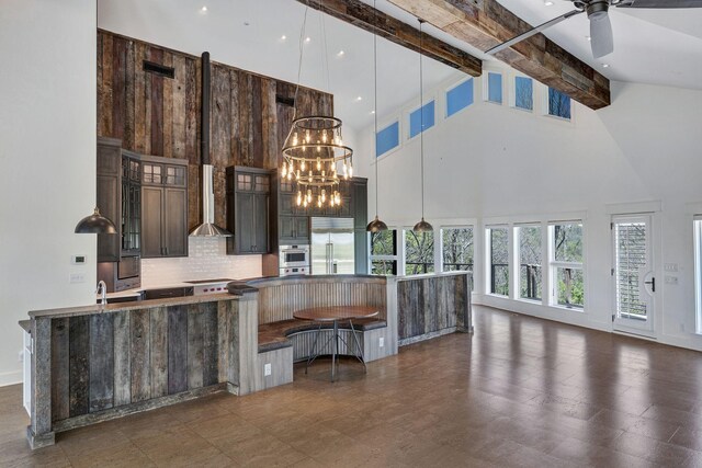 3910 Brick Church Pike, Nashville, TN 37207 - kitchen featuring high vaulted ceiling, appliances with stainless steel finishes, backsplash, a spacious island, and a chandelier