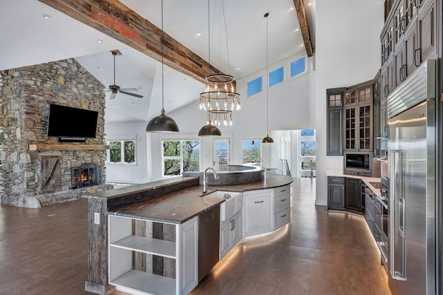 3910 Brick Church Pike, Nashville, TN 37207 - kitchen featuring a sink, built in appliances, open shelves, beam ceiling, and a fireplace