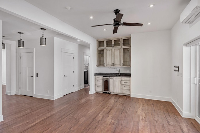 3910 Brick Church Pike, Nashville, TN 37207 - kitchen featuring wine cooler, dark countertops, a wall mounted air conditioner, ceiling fan, and wood finished floors