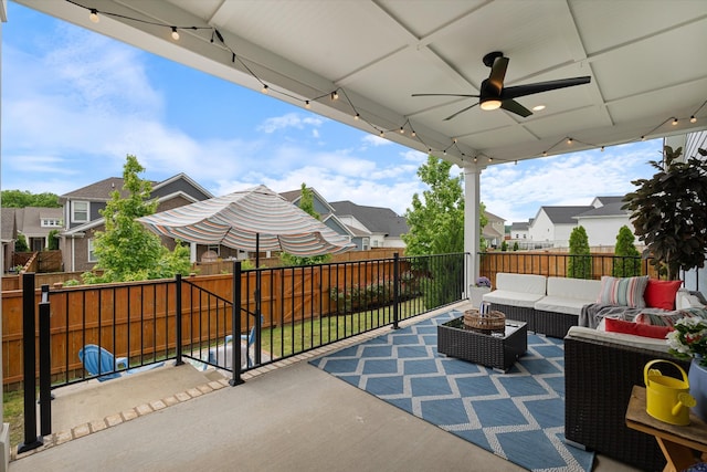 view of patio featuring an outdoor living space, a residential view, a ceiling fan, and fence
