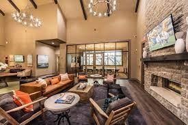community lobby featuring high vaulted ceiling and beam ceiling