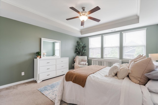 bedroom featuring a tray ceiling, light carpet, multiple windows, crown molding, and baseboards